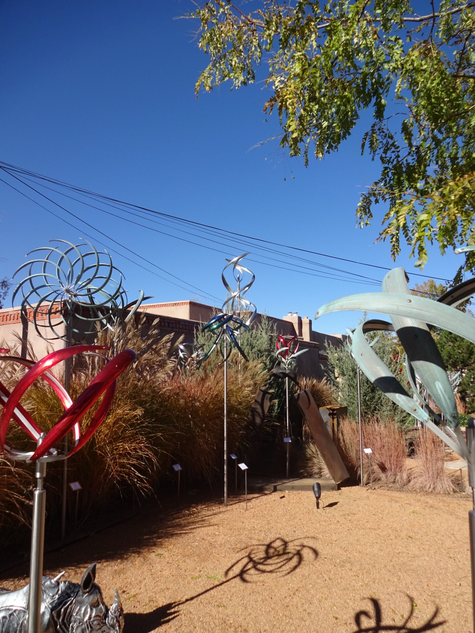 Metal wind sculptures grace the yard at Mark White Fine Art